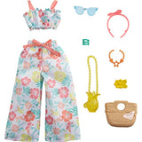 Barbie Storytelling Fashion Pack of Doll Clothes Inspired by Roxy: Matching Floral Top & Pants with 7 Accessories Dolls Including Pineapple Purse, Gift for 3 to 8 Year Olds